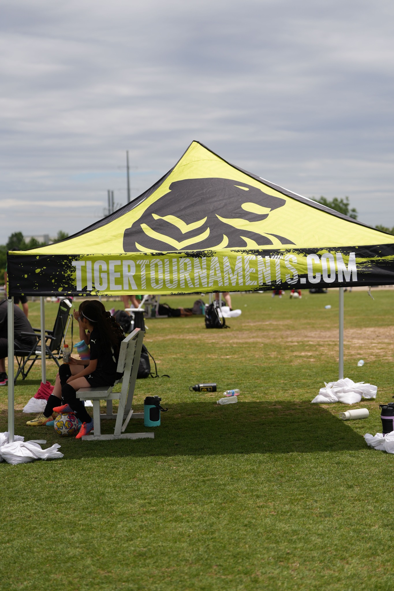 Lime and black branded Tiger team canopy at a soccer tournament